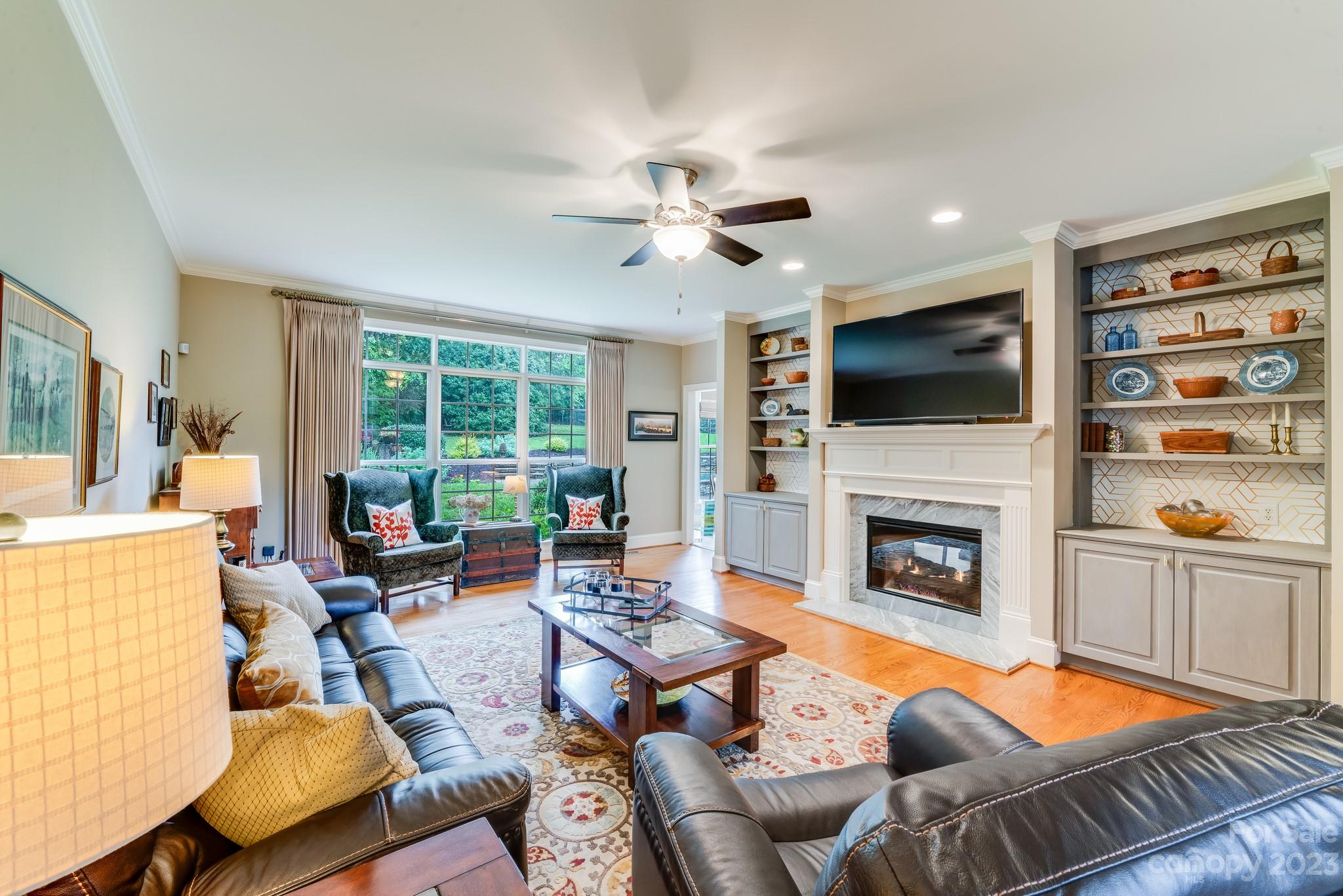 123 Lake Pointe Drive Fort Mill, SC 29708 - Photo 11 of 46 a living room with furniture a fireplace and a flat screen tv