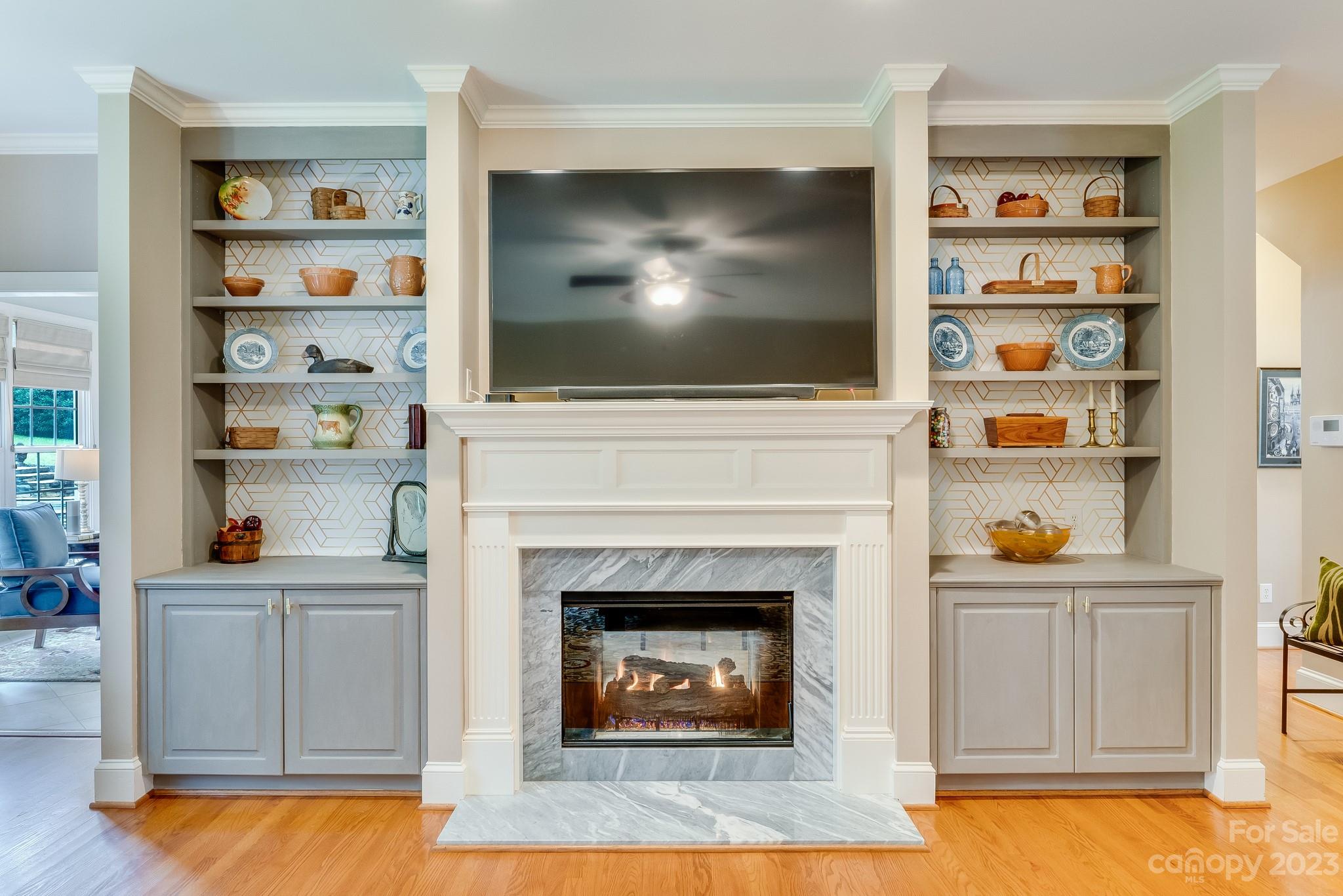 123 Lake Pointe Drive Fort Mill, SC 29708 - Photo 14 of 46 a living room with a fireplace and a flat screen tv