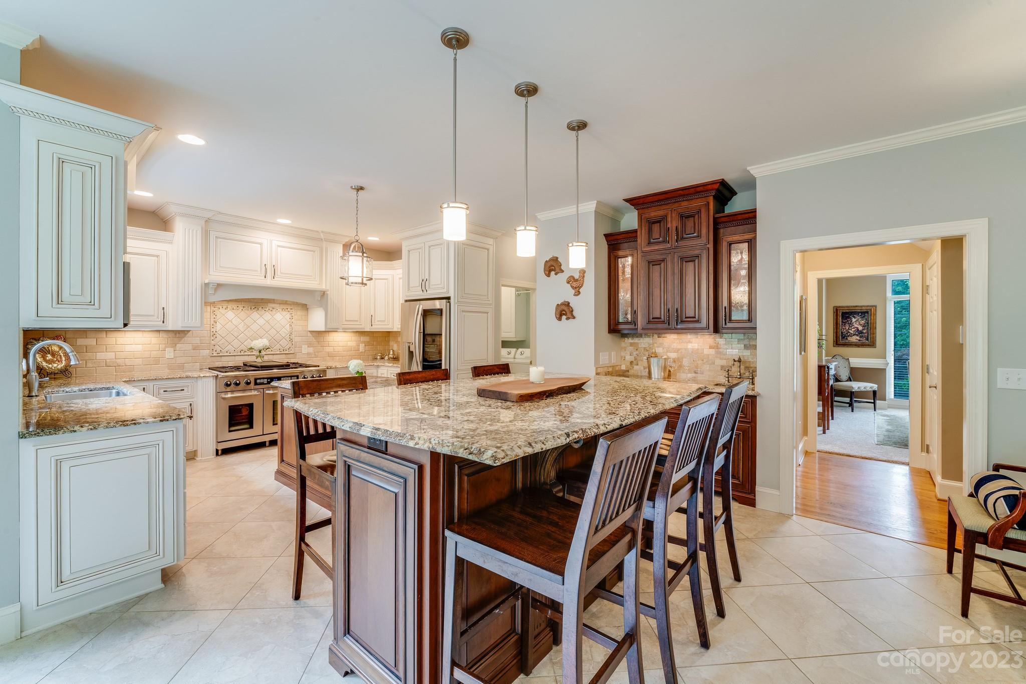 123 Lake Pointe Drive Fort Mill, SC 29708 - Photo 17 of 46 a kitchen with stainless steel appliances kitchen island granite countertop a table chairs sink and cabinets
