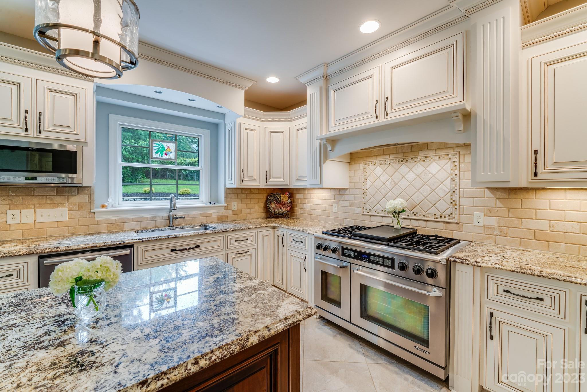 123 Lake Pointe Drive Fort Mill, SC 29708 - Photo 20 of 46 a kitchen with stainless steel appliances granite countertop a stove a sink and a microwave
