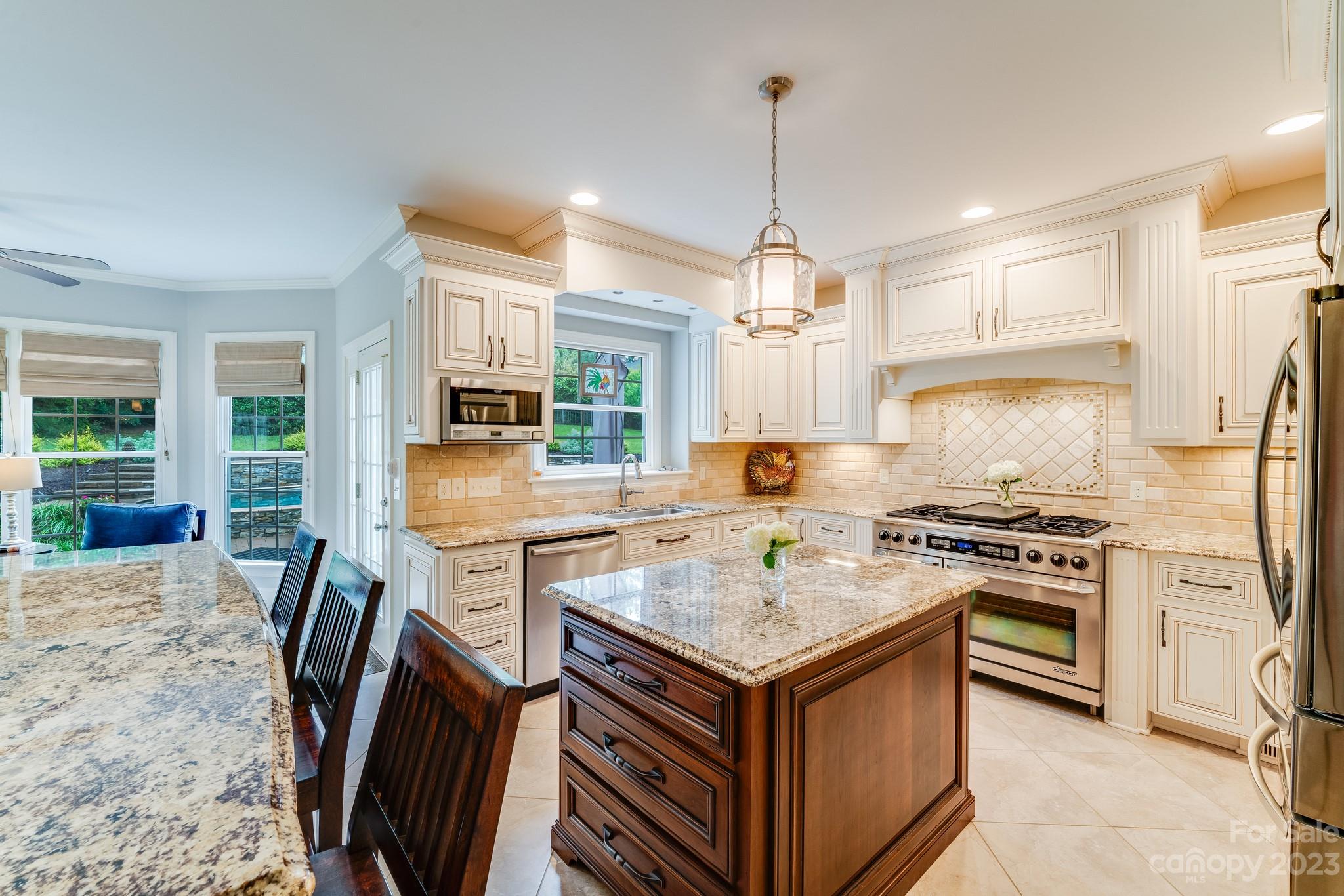 123 Lake Pointe Drive Fort Mill, SC 29708 - Photo 25 of 46 a kitchen with a stove a refrigerator a sink dishwasher a dining table and chairs with wooden floor