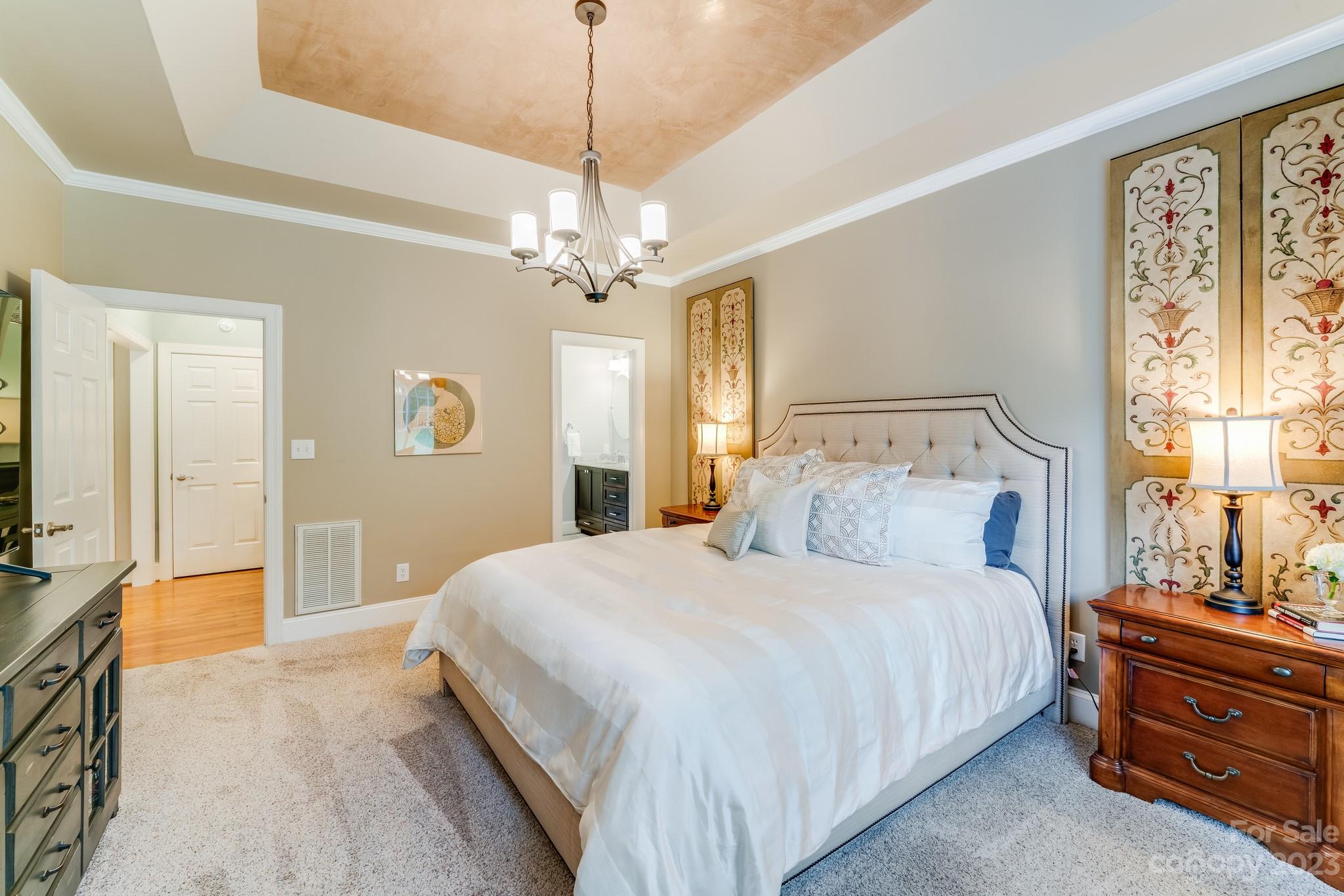 123 Lake Pointe Drive Fort Mill, SC 29708 - Photo 30 of 46 a bedroom with a bed and a chandelier