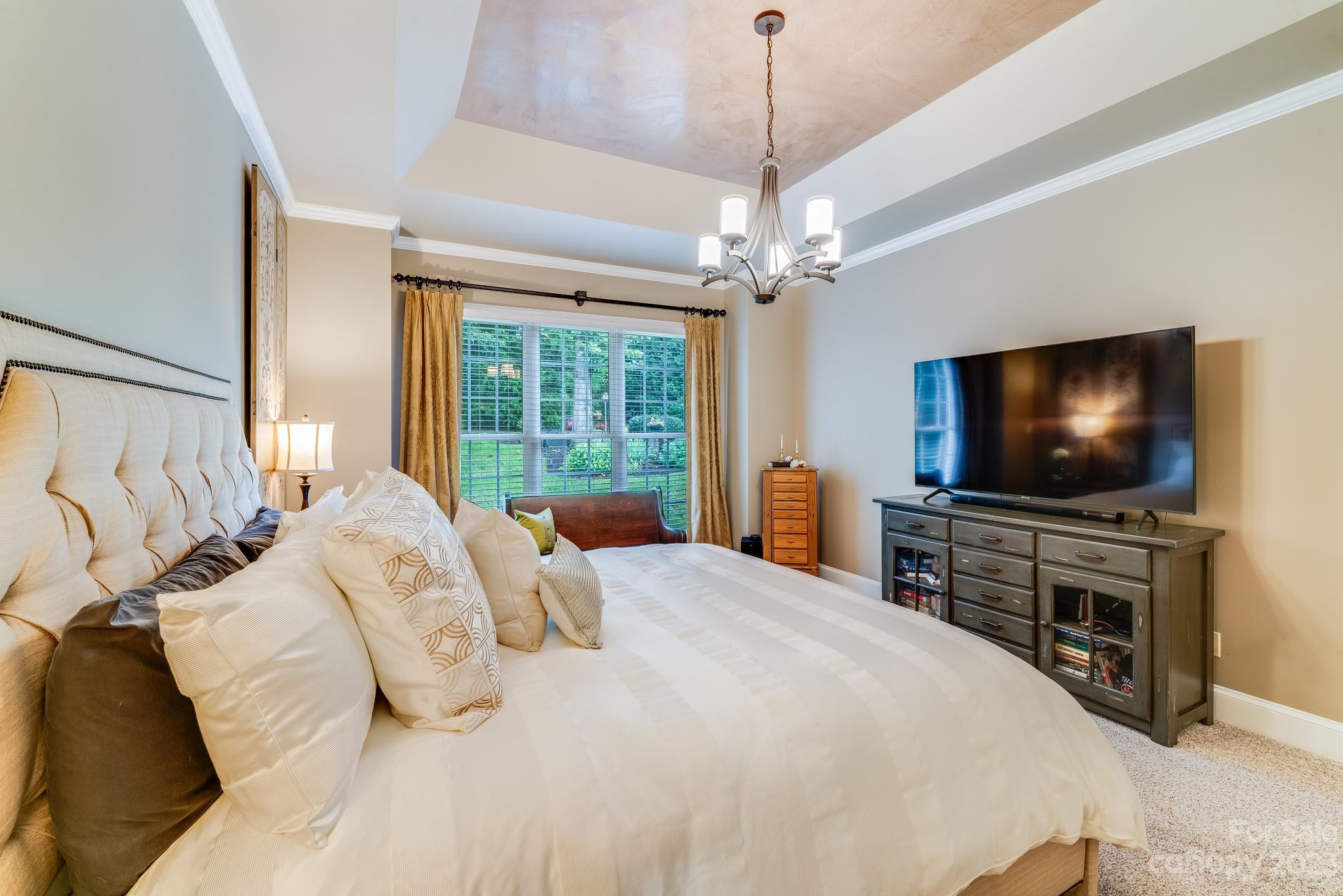 123 Lake Pointe Drive Fort Mill, SC 29708 - Photo 31 of 46 a bedroom with a bed and a flat screen tv