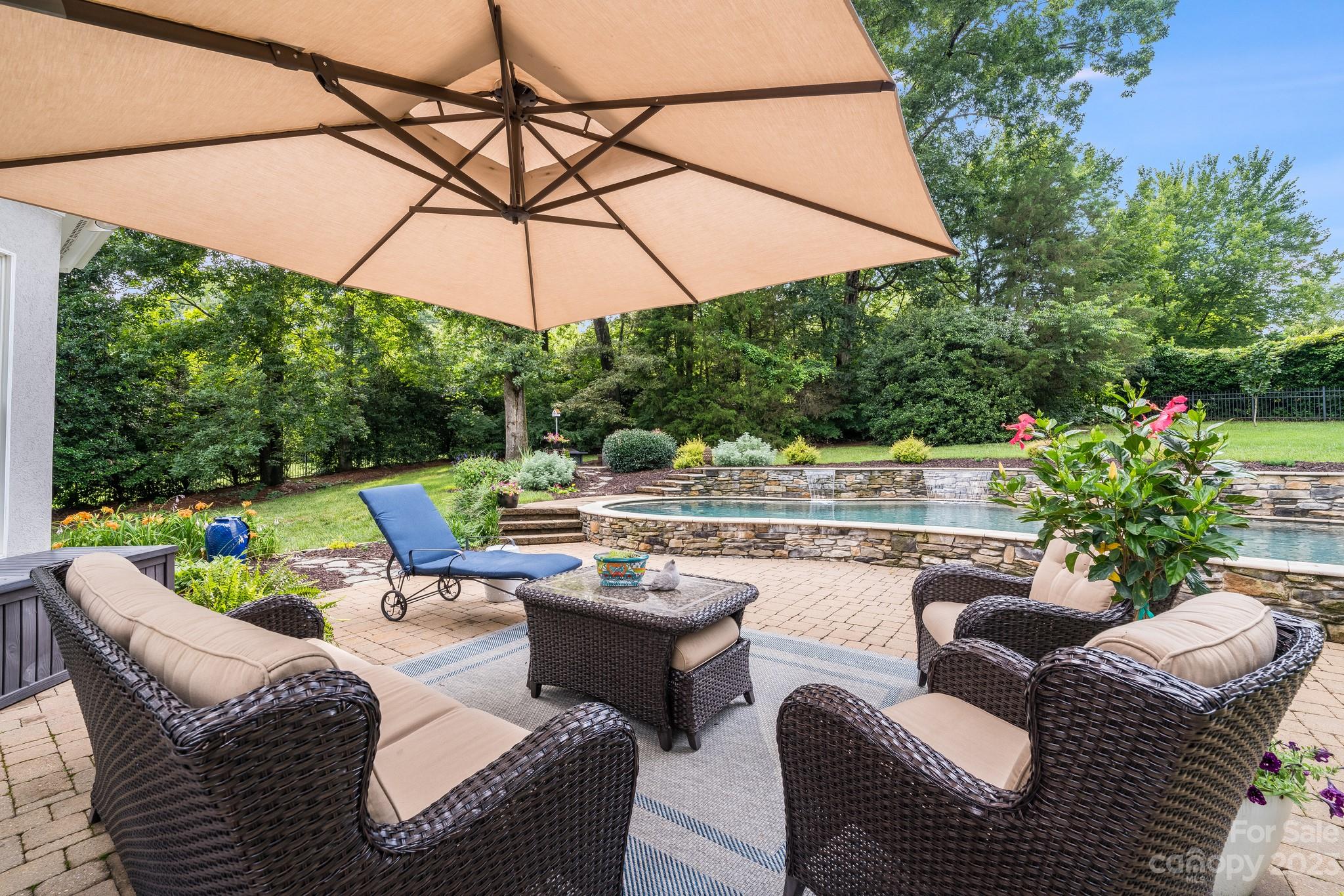 123 Lake Pointe Drive Fort Mill, SC 29708 - Photo 41 of 46 a view of a patio with couches and chairs under an umbrella
