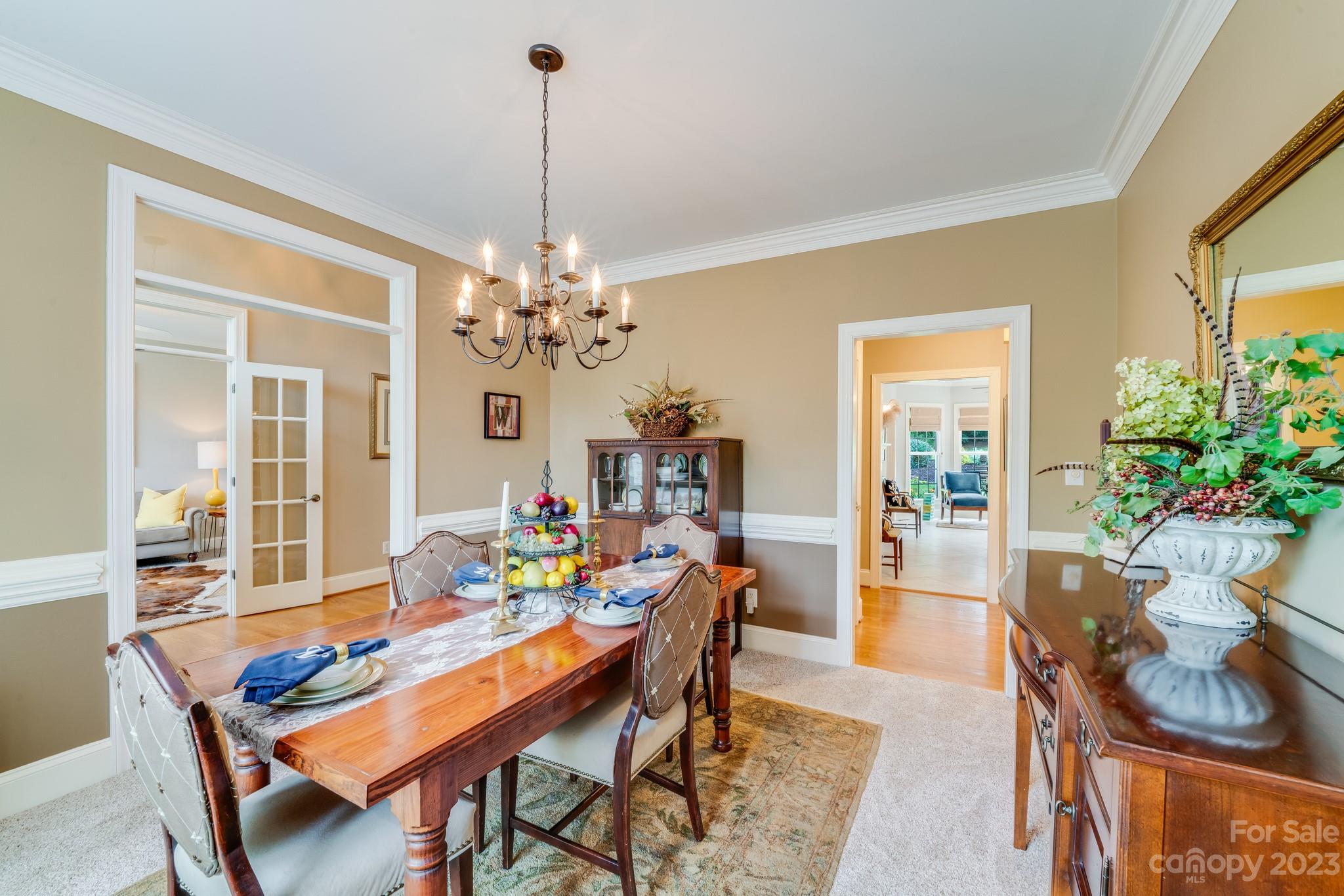 123 Lake Pointe Drive Fort Mill, SC 29708 - Photo 7 of 46 a dining room with furniture a chandelier and wooden floor