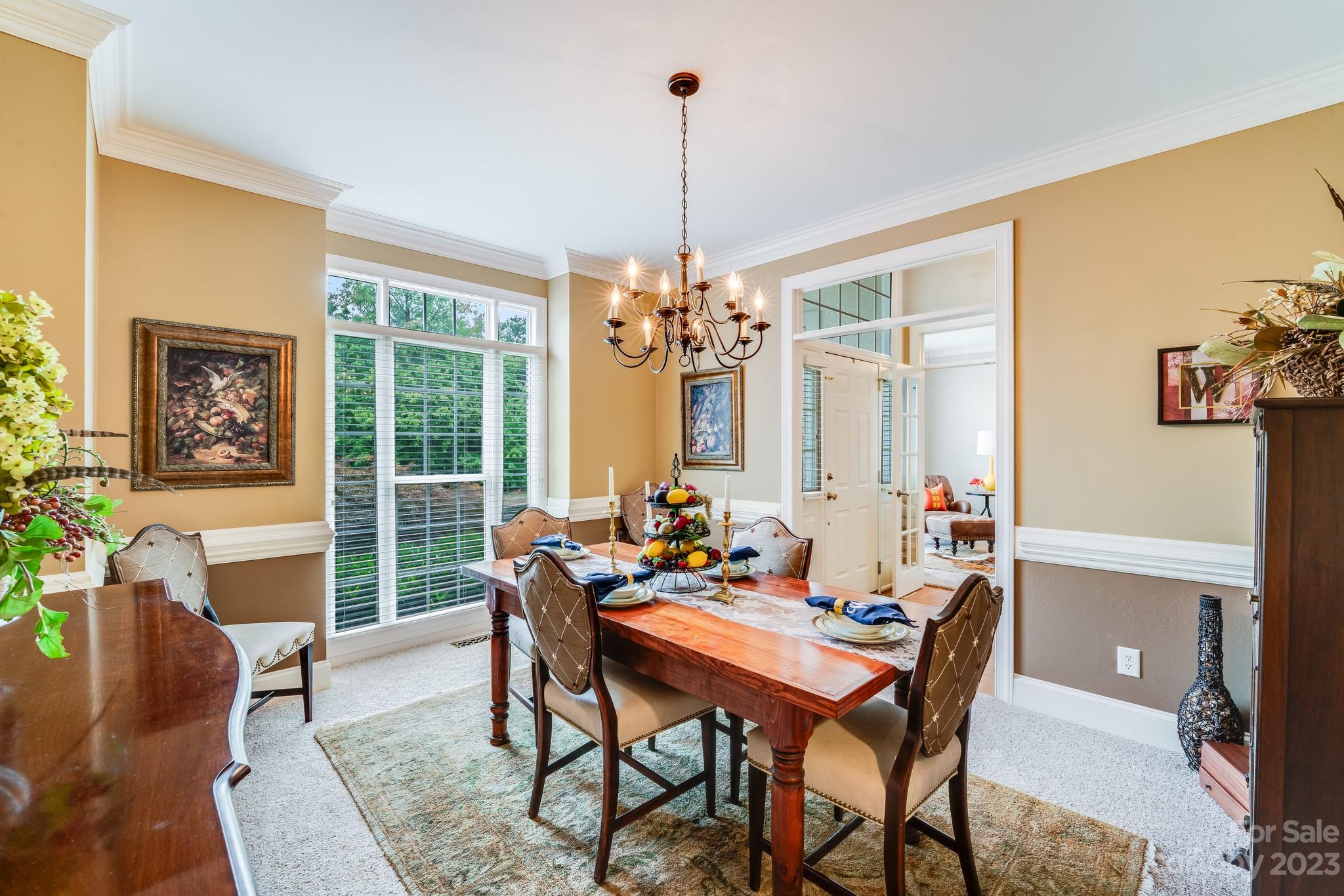 123 Lake Pointe Drive Fort Mill, SC 29708 - Photo 8 of 46 a dining room with furniture a chandelier and wooden floor