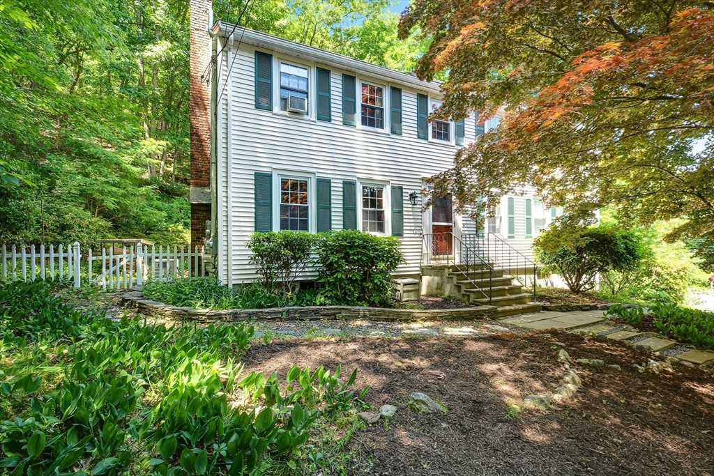 a view of backyard of house with green space