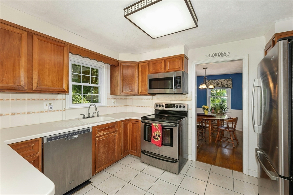 1 Kevin Circle Framingham, MA 01701 - Photo 13 of 25 a kitchen with stainless steel appliances granite countertop a sink stove and refrigerator