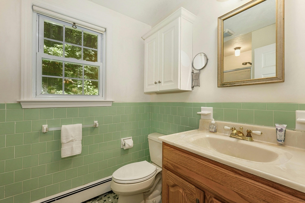 1 Kevin Circle Framingham, MA 01701 - Photo 17 of 25 a bathroom with a granite countertop toilet sink and mirror
