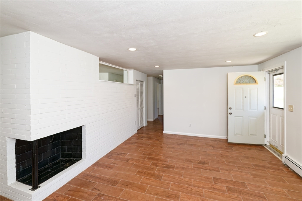 35 Marion Street Holbrook, MA 02343 - Photo 11 of 37 a view of an empty room with wooden floor and cabinet