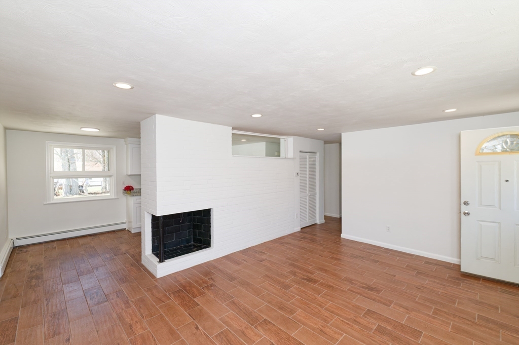 35 Marion Street Holbrook, MA 02343 - Photo 12 of 37 an empty room with wooden floor and windows