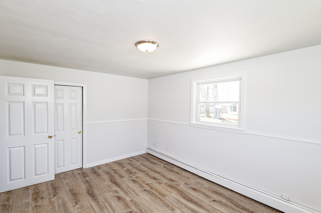 35 Marion Street Holbrook, MA 02343 - Photo 14 of 37 an empty room with wooden floor and windows