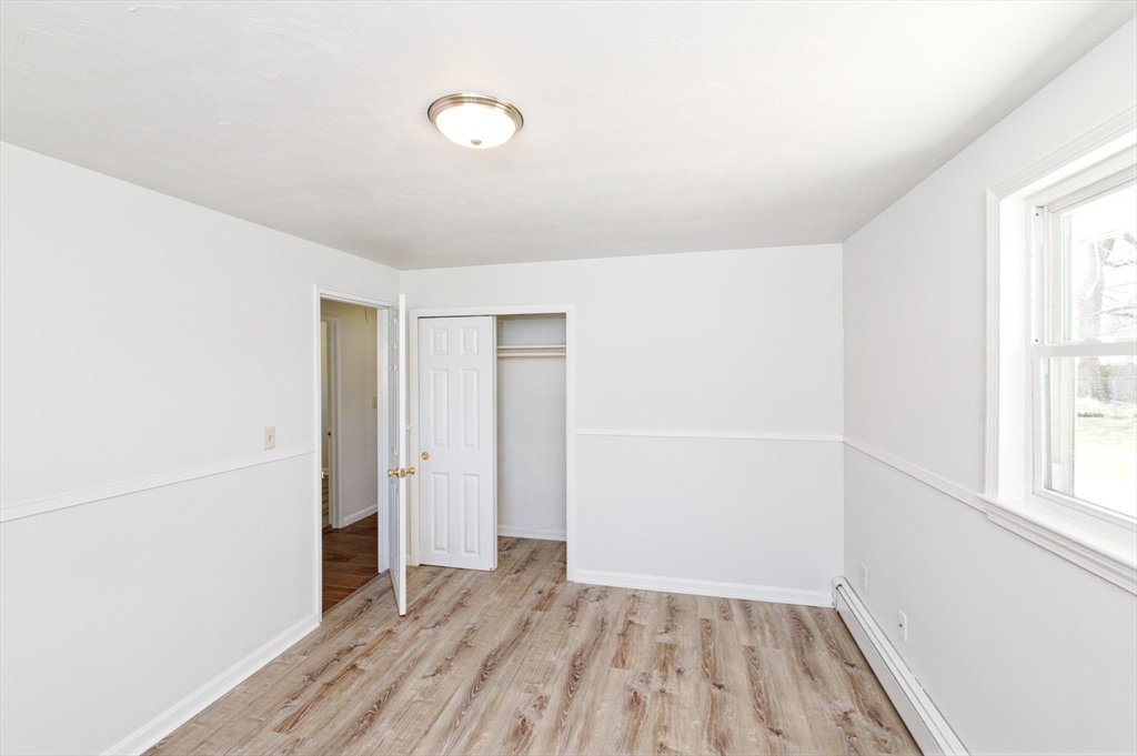35 Marion Street Holbrook, MA 02343 - Photo 16 of 37 an empty room with wooden floor and windows