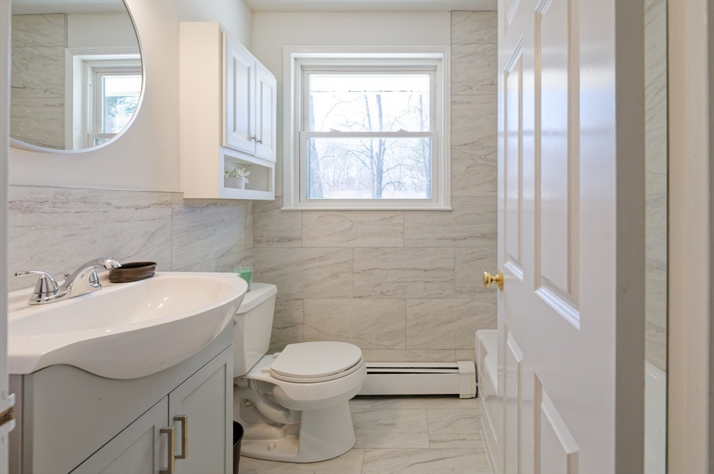35 Marion Street Holbrook, MA 02343 - Photo 20 of 37 a bathroom with a toilet sink and mirror