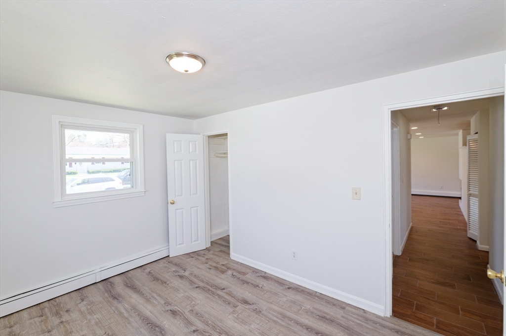 35 Marion Street Holbrook, MA 02343 - Photo 21 of 37 an empty room with wooden floor and windows