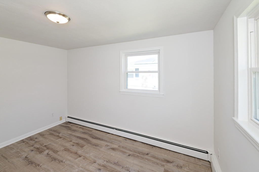35 Marion Street Holbrook, MA 02343 - Photo 23 of 37 an empty room with a workbench