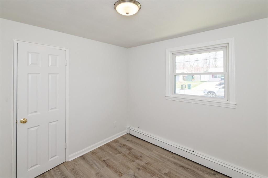 35 Marion Street Holbrook, MA 02343 - Photo 25 of 37 an empty room with wooden floor and windows