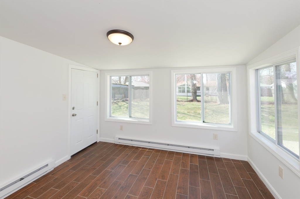 35 Marion Street Holbrook, MA 02343 - Photo 27 of 37 an empty room with wooden floor and windows
