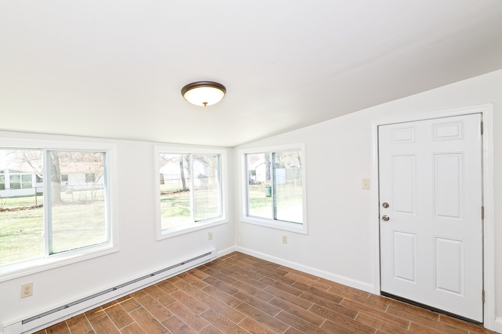 35 Marion Street Holbrook, MA 02343 - Photo 28 of 37 a view of an empty room with wooden floor and a window