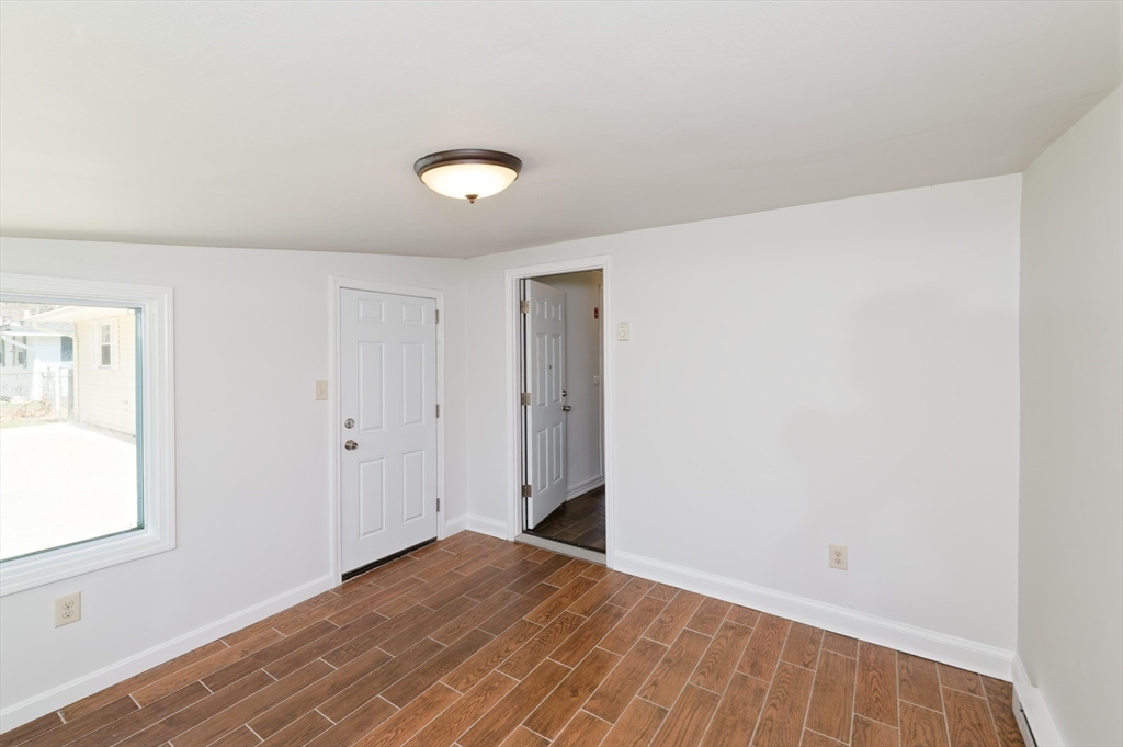 35 Marion Street Holbrook, MA 02343 - Photo 30 of 37 an empty room with wooden floor and windows
