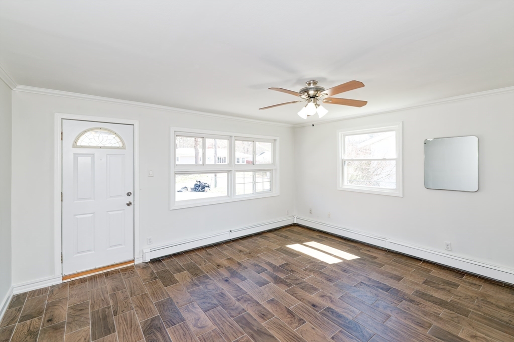 35 Marion Street Holbrook, MA 02343 - Photo 3 of 37 an empty room with wooden floor chandelier fan and windows