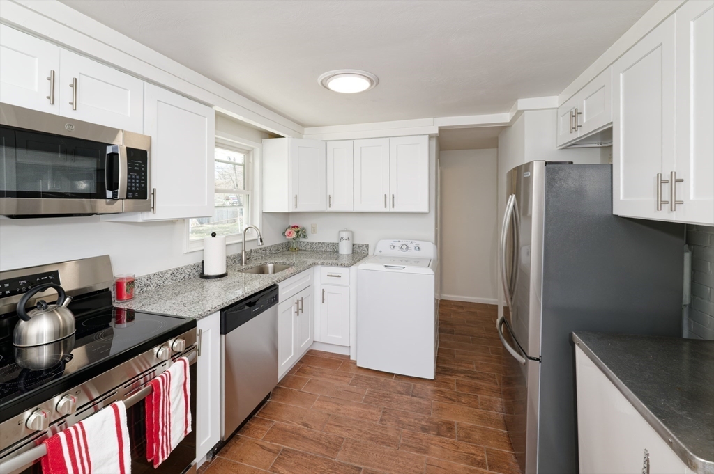 35 Marion Street Holbrook, MA 02343 - Photo 5 of 37 a kitchen with stainless steel appliances granite countertop a sink stove and refrigerator