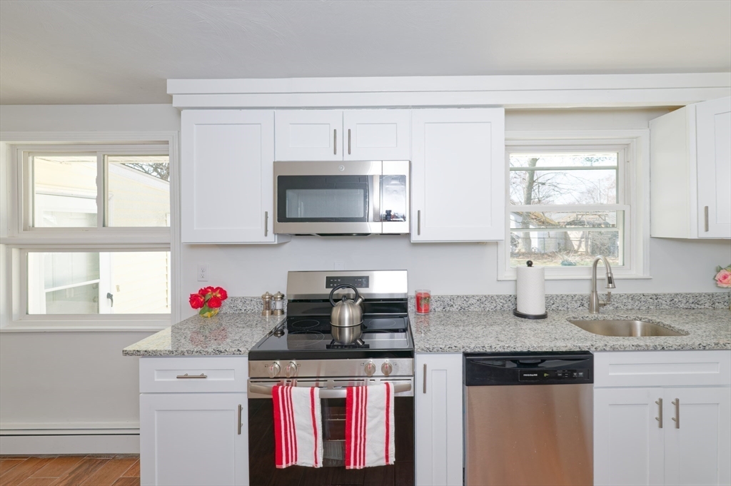35 Marion Street Holbrook, MA 02343 - Photo 6 of 37 a kitchen with stainless steel appliances granite countertop a stove microwave and cabinets