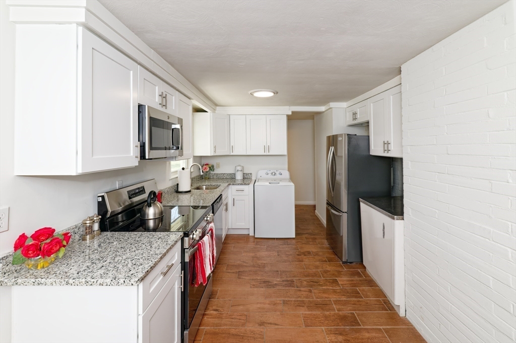 35 Marion Street Holbrook, MA 02343 - Photo 7 of 37 a kitchen with a sink stove and refrigerator