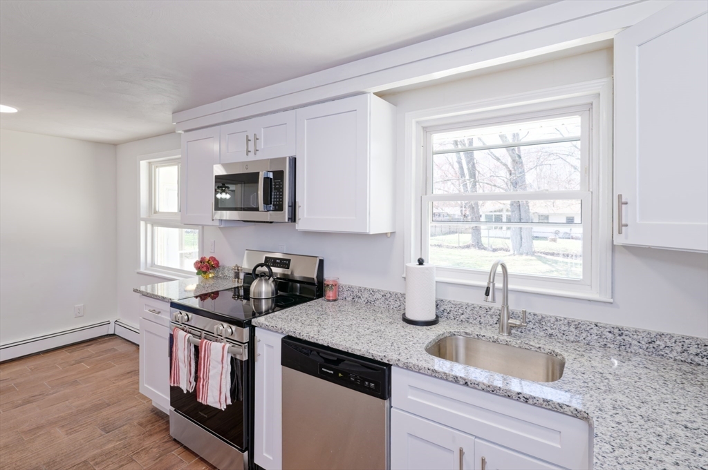 35 Marion Street Holbrook, MA 02343 - Photo 9 of 37 a kitchen with granite countertop a sink and a stove top oven