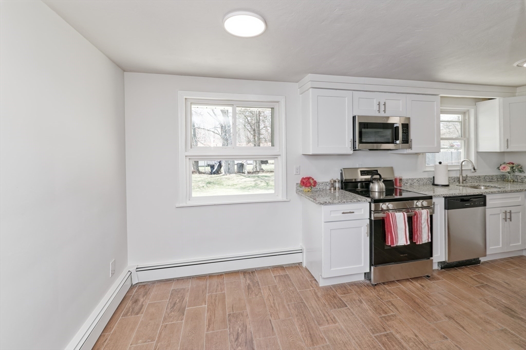 35 Marion Street Holbrook, MA 02343 - Photo 10 of 37 a kitchen with a refrigerator and a stove top oven
