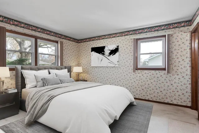 a bedroom with a bed and a painting on the wall