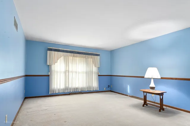 an empty room with windows and table