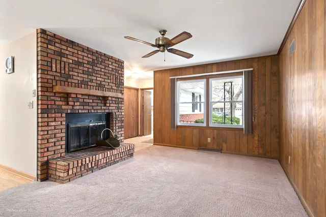 a living room with a fireplace and a window