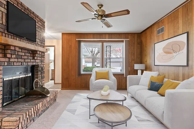 a living room with furniture a fireplace and a flat screen tv