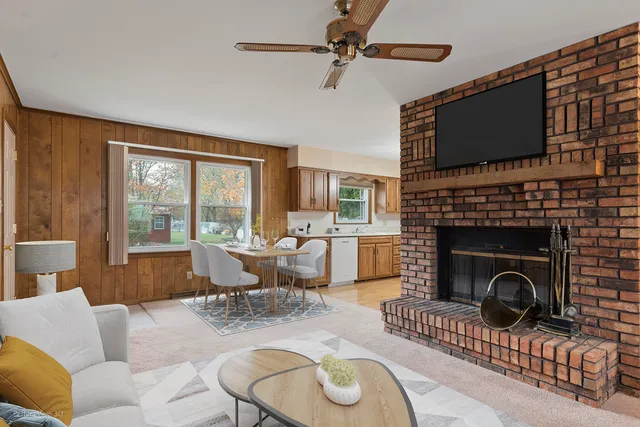a living room with furniture a flat screen tv and a fireplace