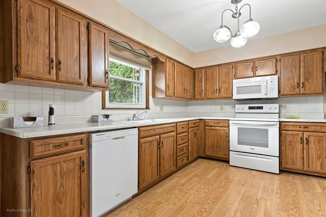a kitchen with cabinets a sink and appliances