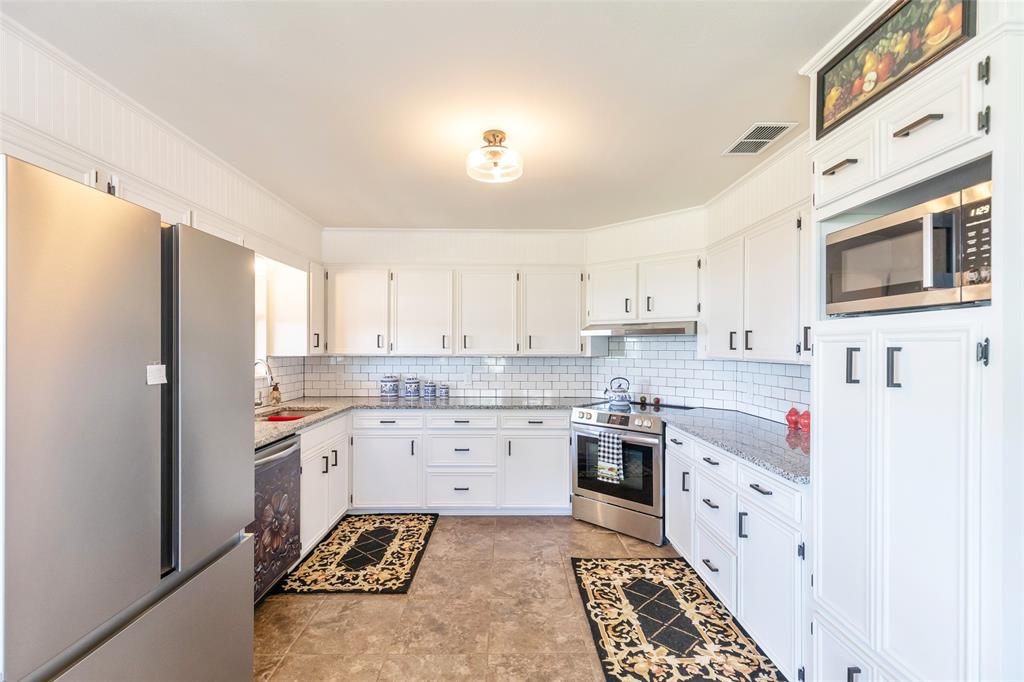 642 Fm 3200 Comanche, TX 76442 - Photo 6 of 37 a kitchen with stainless steel appliances a stove a sink and a refrigerator