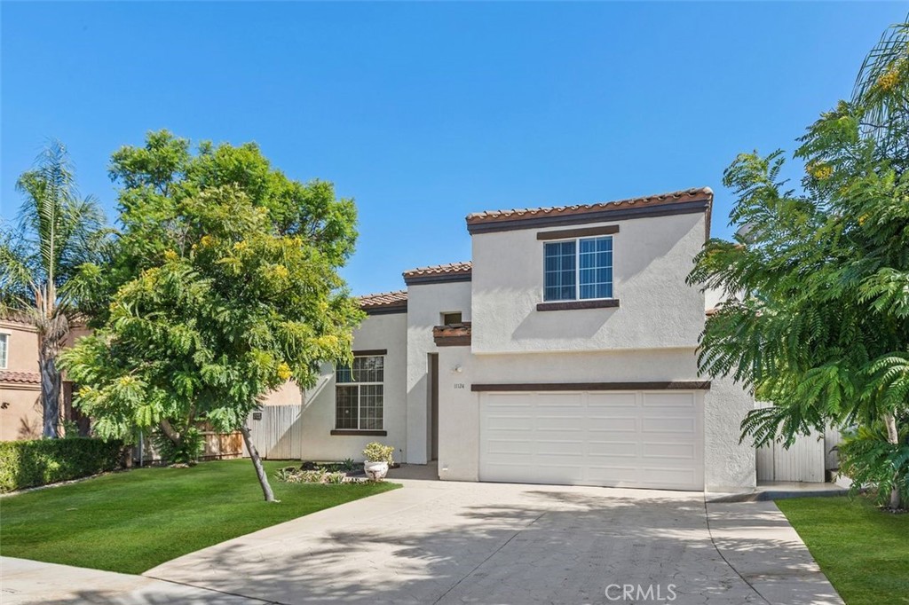 11124 Baker Lane Riverside, CA 92505 - Photo 1 of 1 a front view of a house with a garden