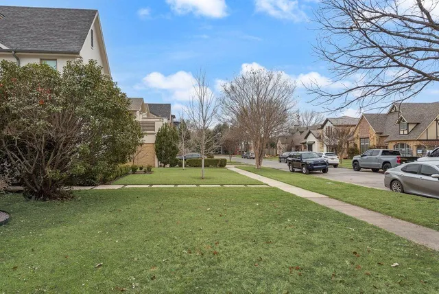 a view of road with houses and trees