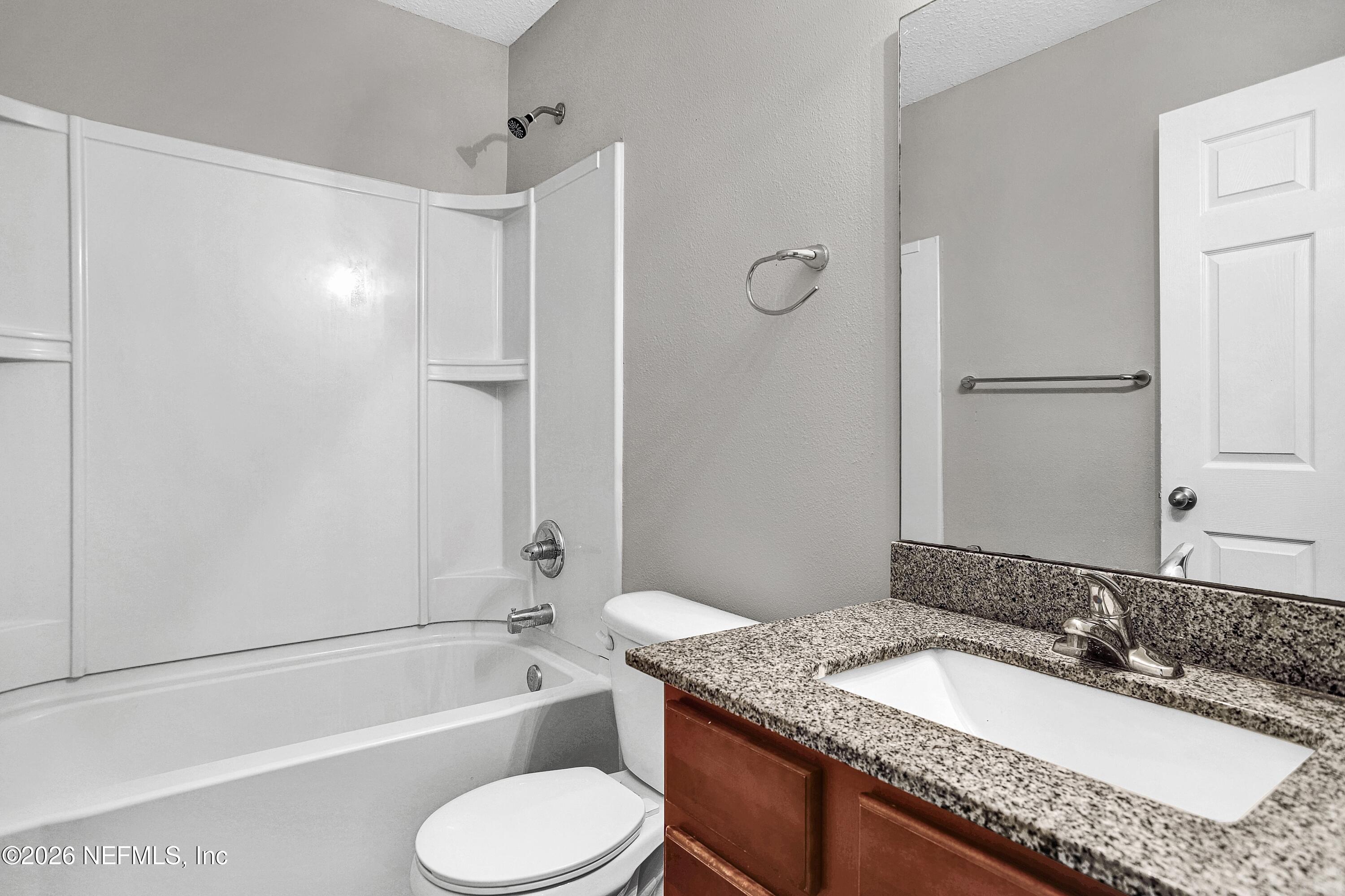 12271 Harts Road Jacksonville, FL 32218 - Photo 13 of 17 a bathroom with a granite countertop sink toilet bathtub and shower