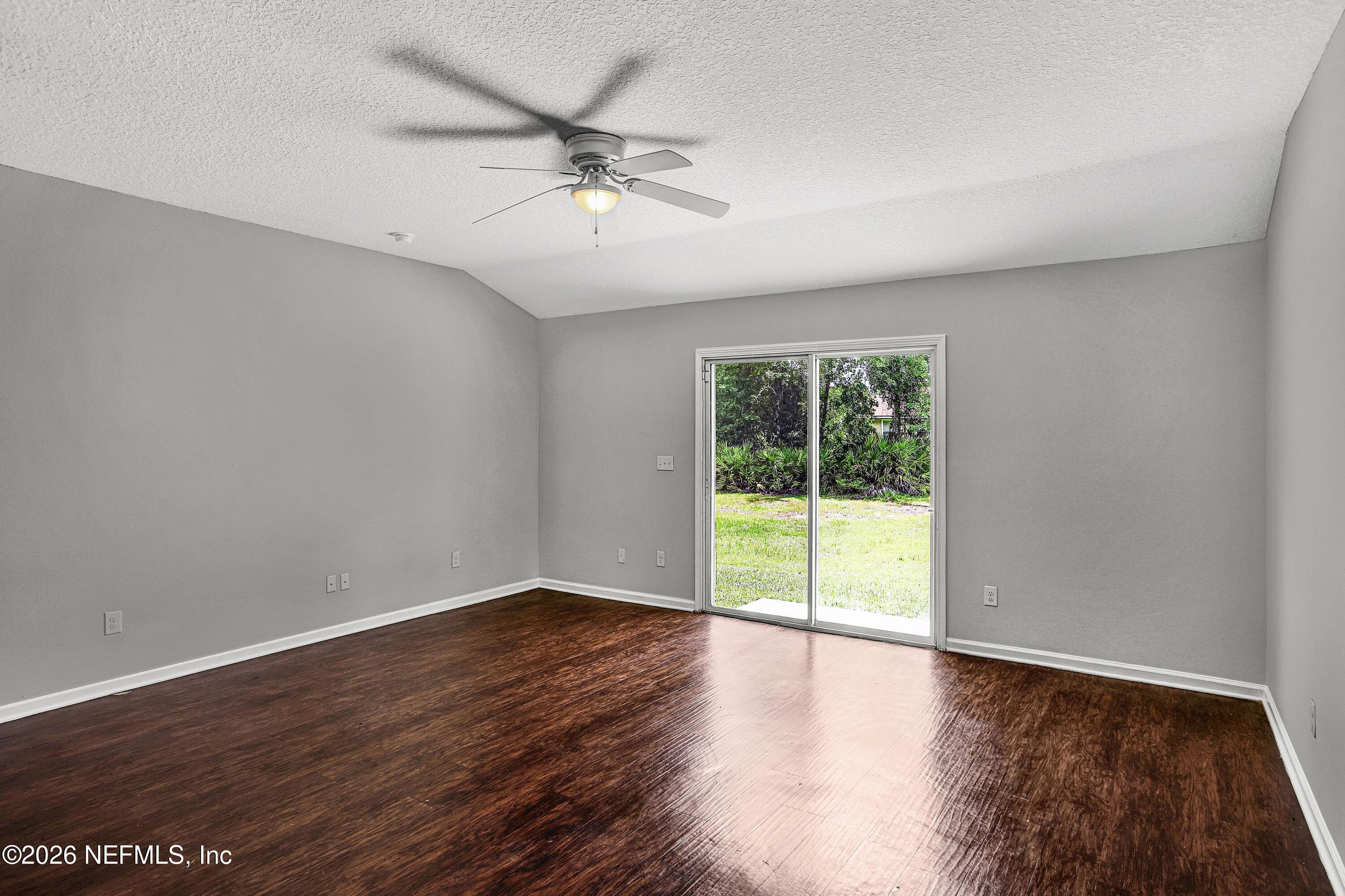 12271 Harts Road Jacksonville, FL 32218 - Photo 5 of 17 a view of an empty room with wooden floor and a window