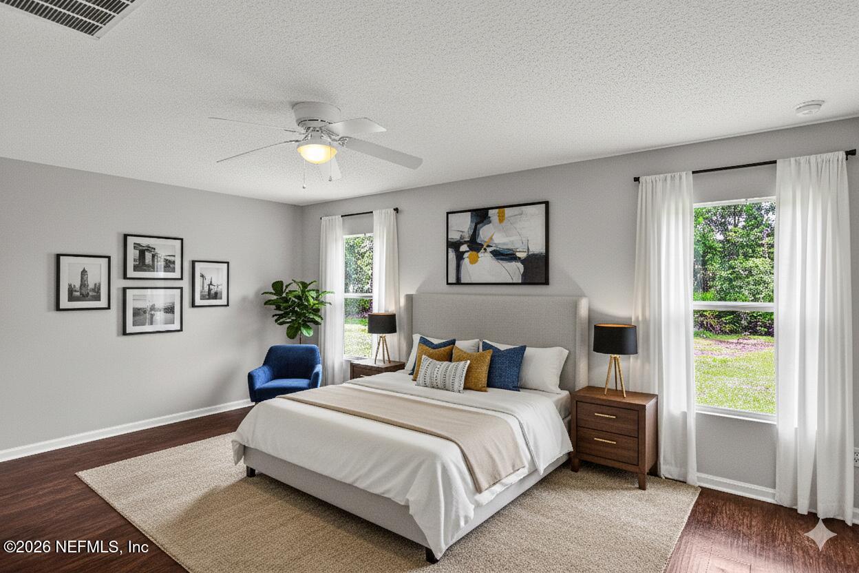 12271 Harts Road Jacksonville, FL 32218 - Photo 6 of 17 a bedroom with a large bed and a window
