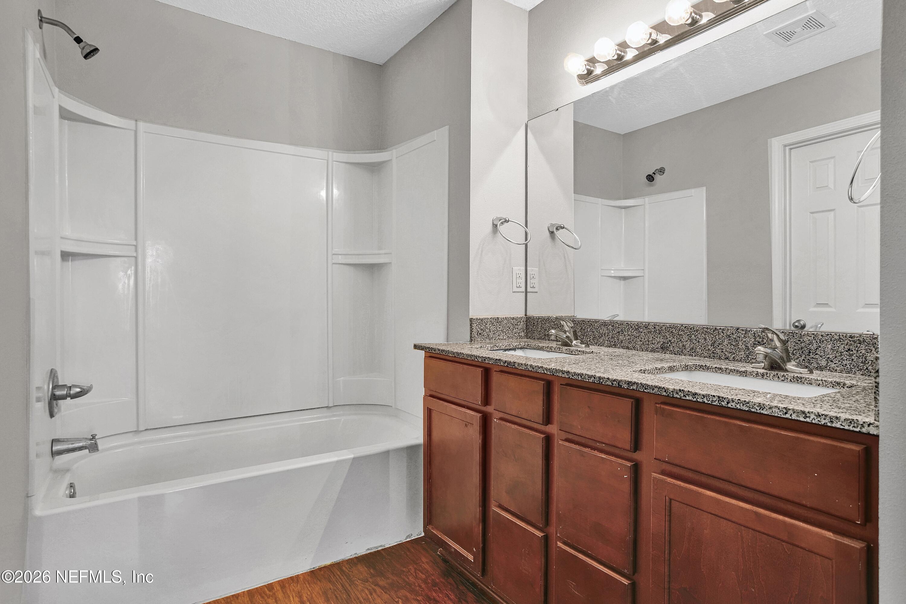 12271 Harts Road Jacksonville, FL 32218 - Photo 8 of 17 a bathroom with a granite countertop sink and a mirror