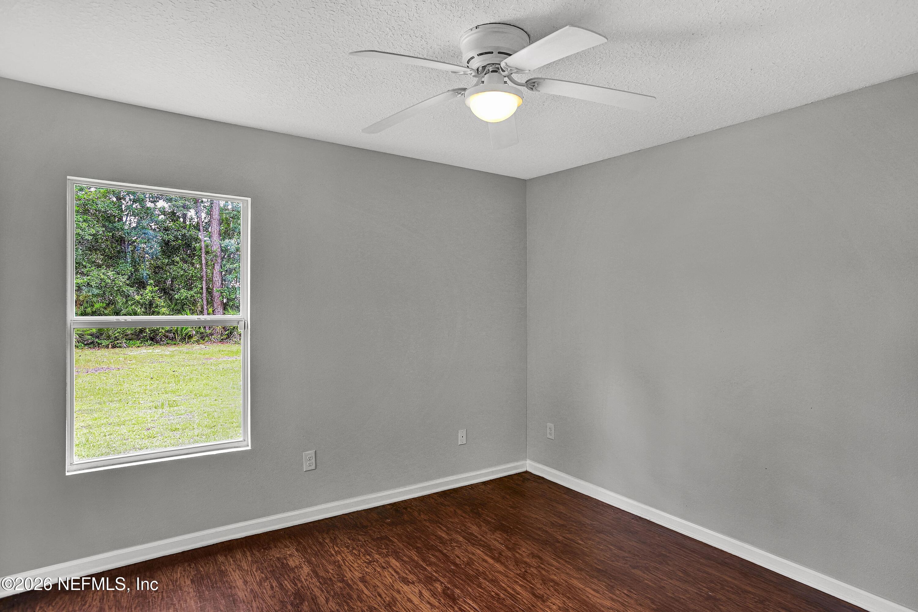 12271 Harts Road Jacksonville, FL 32218 - Photo 10 of 17 wooden floor in an empty room with a window