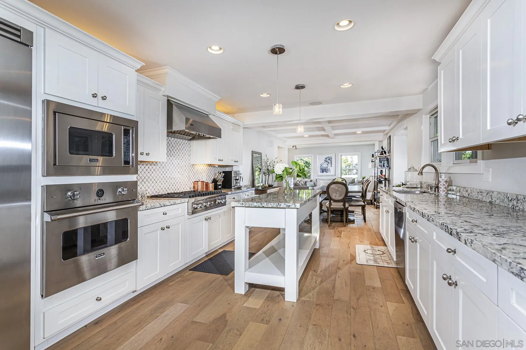 340 A Avenue Coronado, CA 92118 - Photo 13 of 41 a kitchen with white cabinets and stainless steel appliances