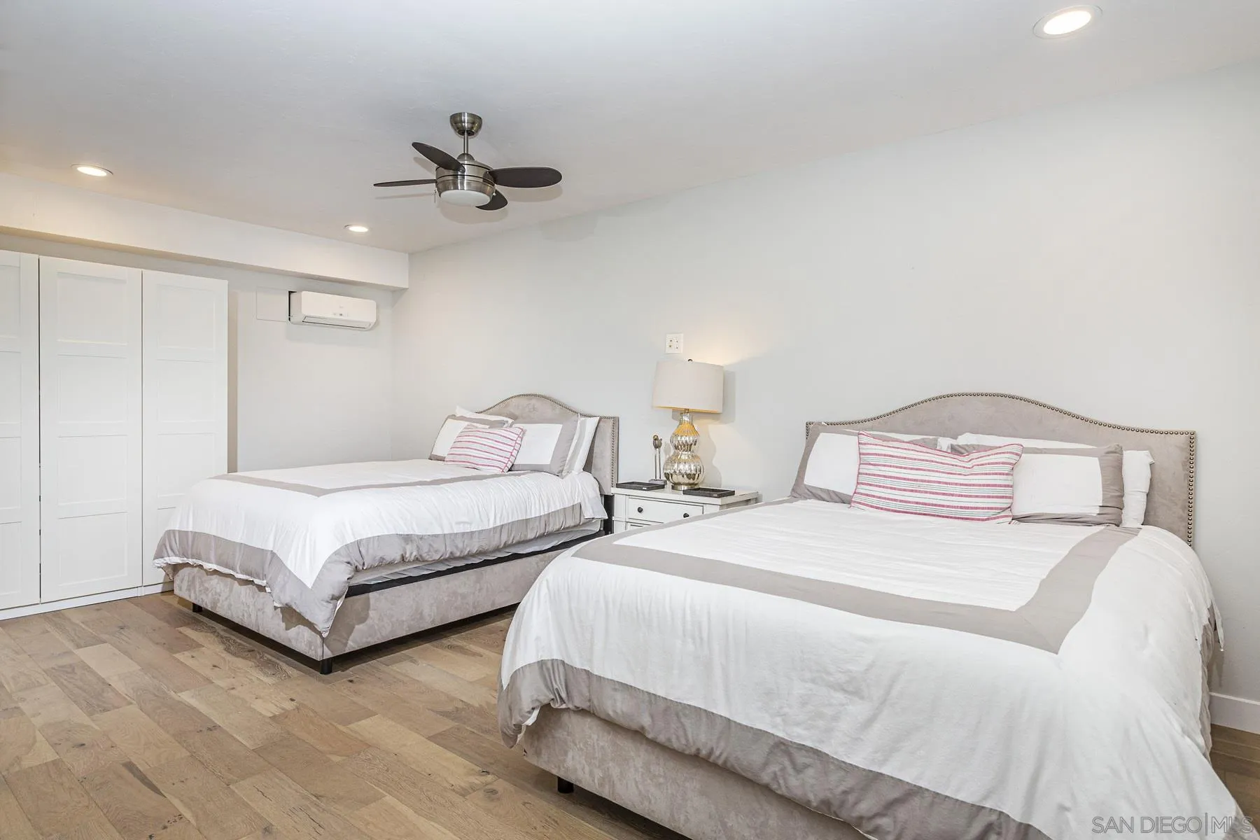 340 A Avenue Coronado, CA 92118 - Photo 19 of 41 a spacious bedroom with two bed and a chandelier