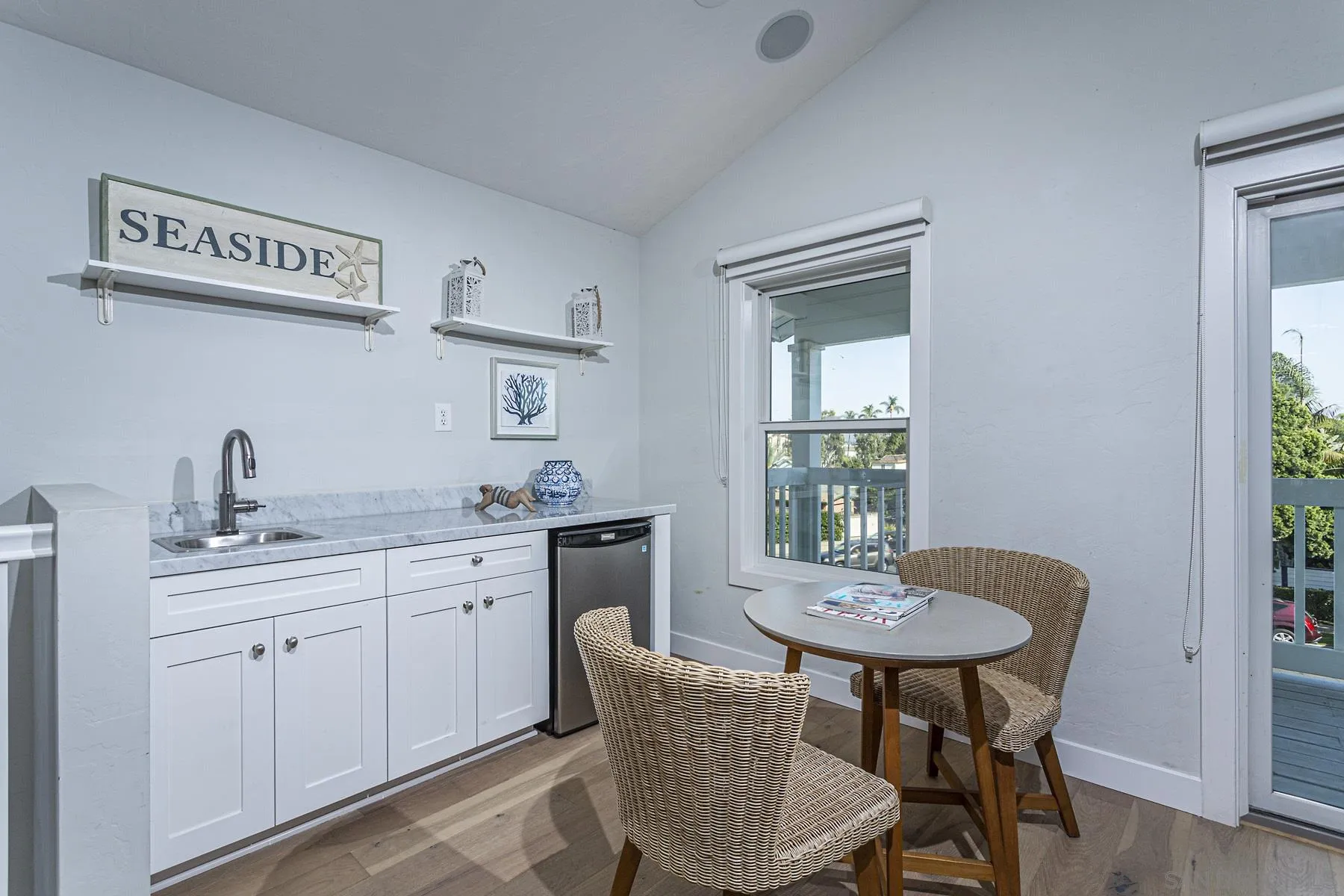 340 A Avenue Coronado, CA 92118 - Photo 23 of 41 a kitchen with a sink table and chairs