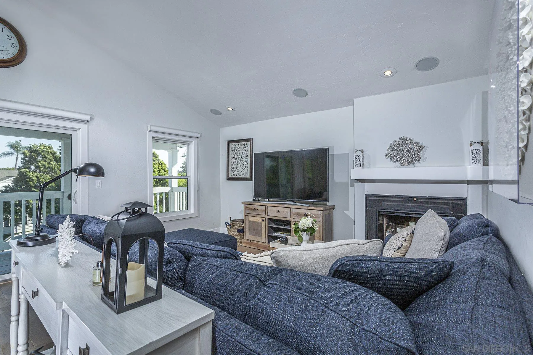 340 A Avenue Coronado, CA 92118 - Photo 25 of 41 a living room with furniture a flat screen tv and a fireplace