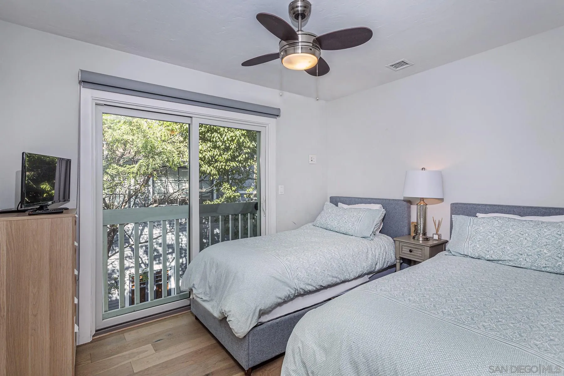 340 A Avenue Coronado, CA 92118 - Photo 32 of 41 a bedroom with two large bed and a large window