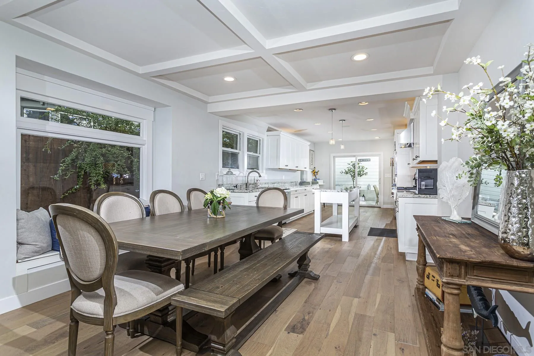 340 A Avenue Coronado, CA 92118 - Photo 9 of 41 a dining room with furniture a window and wooden floor
